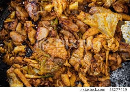Stir-fried chicken ribs with chicken, cabbage, vegetables, spicy seasoning, and tteokbokki, traditional Korean food Stir-fried chicken ribs with chicken, cabbage, vegetables, spicy seasoning, and tteokbokki, traditional Korean food 88277419