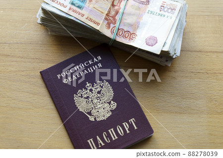 Russian rubles banknotes and passport. Translation: Russian Federation passport. Inflation, sanctions and the fall of the Russian economy concept. Falling cash savings and budget Russian rubles banknotes and passport. Translation: Russian Federation passport. Inflation, sanctions and the fall of the Russian economy concept. Falling cash savings and budget 88278039