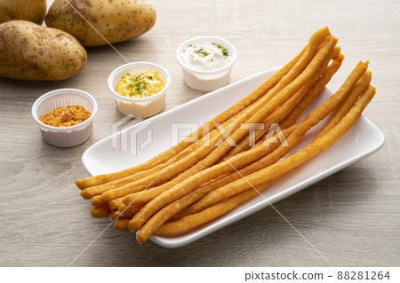 Unique street food from potato.jerked potato with long shape on white plate with sauce Unique street food from potato.jerked potato with long shape on white plate with sauce 88281264