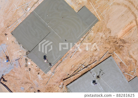 Worker labor the working polishing scrubbing with concrete cement foundation floor at house under construction 88281625