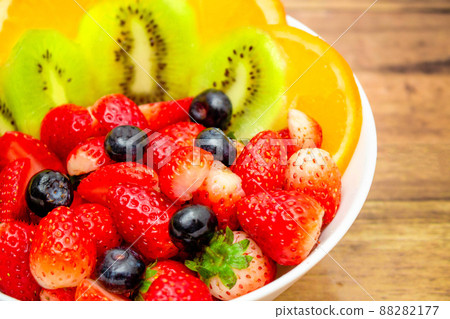 Fresh fruits concept, Fruits salad consist of kiwi and assorted berry in bowl on wooden background 88282177