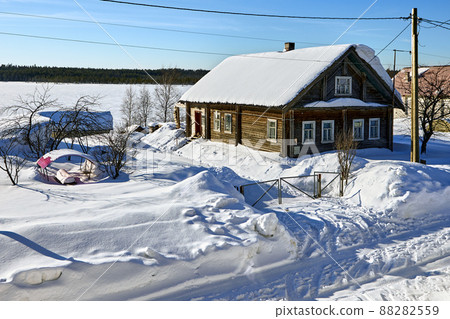 Snowdrifts near rural buildings in countryside in northern Finland at winter day. 88282559