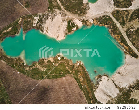 Aerial drone view Amazing industrial landscape, on Emerald lake in a flooded quarry Aerial drone view Amazing industrial landscape, on Emerald lake in a flooded quarry 88282582
