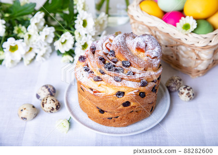 Craffin (Cruffin) with raisins and candied fruits. Easter Bread Kulich and painted eggs. Easter Holiday. Close-up. Craffin (Cruffin) with raisins and candied fruits. Easter Bread Kulich and painted eggs. Easter Holiday. Close-up. 88282600