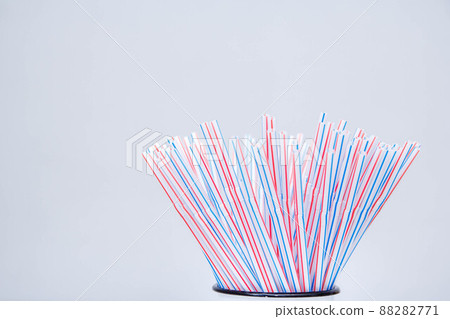 Drinking plastic straws on a gray background. Colorful of plastic straws used for drinking water or soft drinks. Copy space Drinking plastic straws on a gray background. Colorful of plastic straws used for drinking water or soft drinks. Copy space 88282771