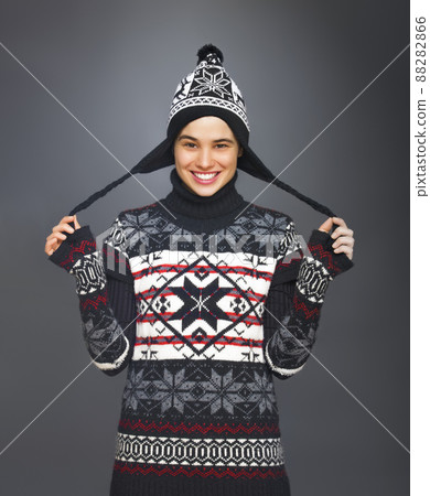 Smiling Girl with Funny Winter Hat. Studio portrait of a cute young woman dressed for winter. Smiling Girl with Funny Winter Hat. Studio portrait of a cute young woman dressed for winter. 88282866