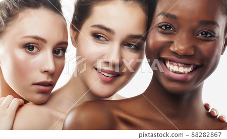 three different nation woman: african-american, caucasian together isolated on white background happy smiling, diverse type on skin, lifestyle real people concept three different nation woman: african-american, caucasian together isolated on white background happy smiling, diverse type on skin, lifestyle real people concept 88282867