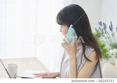 Female smartphone calling PC living room 88283231