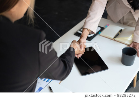 Young business asian people shaking hands in the office. Finishing successful meeting. 88283272