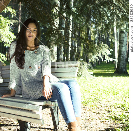 Young cute smiling real stylish dressed woman in green palm park smiling, resting, enjoing, lifestyle outside concept Young cute smiling real stylish dressed woman in green palm park smiling, resting, enjoing, lifestyle outside concept 88283680