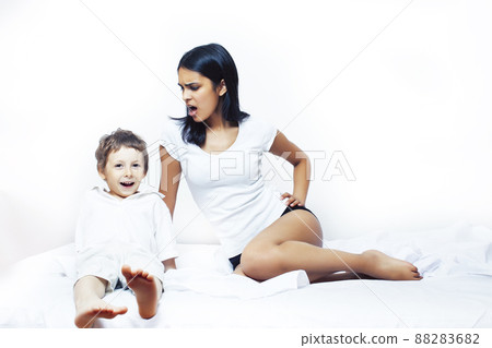 cute little boy in bed with mother in pajamas having fun happy smiling, lifestyle people concept cute little boy in bed with mother in pajamas having fun happy smiling, lifestyle people concept 88283682