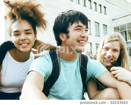 cute group of teenages at the building of university with books huggings, diversity nations, having lunch closeup cute group of teenages at the building of university with books huggings, diversity nations, having lunch closeup 88283683