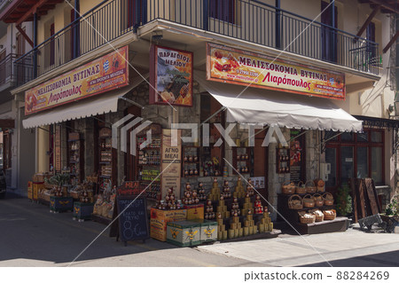 Outdoor showcase day view of local honey products Greek shop with sign. 88284269