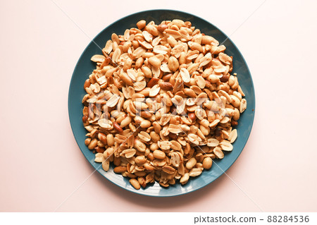 Processed pea nuts in a bowl on table top down . Processed pea nuts in a bowl on table top down . 88284536