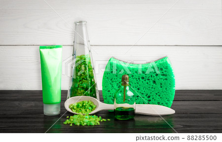 Green composition beauty treatment products in green colors: shampoo, soap, bath salt, oil. Green composition beauty treatment products in green colors: shampoo, soap, bath salt, oil. 88285500