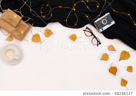 Autumn accessories for woman with yellow leaves and coffee with milk, top view Autumn accessories for woman with yellow leaves and coffee with milk, top view 88286117