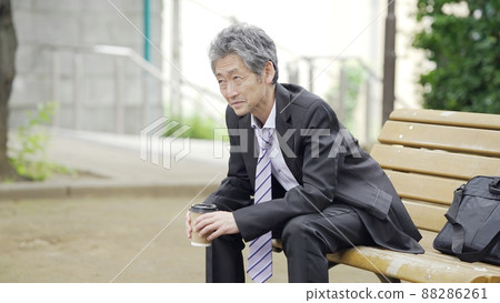A businessman twilight in the park A businessman twilight in the park 88286261