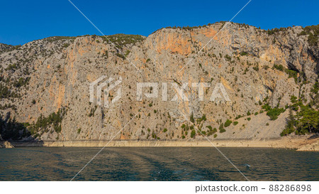 Sheer scarred cliff at the entrance to a Green Canyon in Turkey 88286898