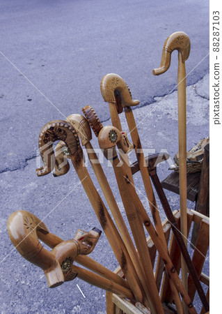Glitsa decorated wooden carved walking sticks, on display at a shop exterior. Glitsa decorated wooden carved walking sticks, on display at a shop exterior. 88287103
