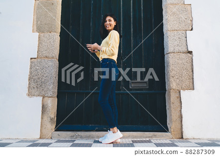 Full length portrait of casual dressed female tourist enjoying travel vacations posing at street urban 88287309