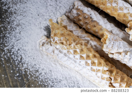 thin crispy waffles lie on a black table 88288323