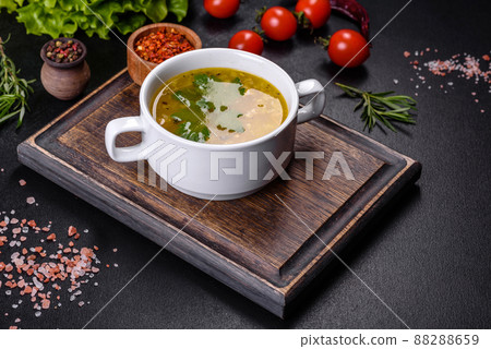 Hot tasty healthy soup with fish and vegetables served on a round plate Hot tasty healthy soup with fish and vegetables served on a round plate 88288659