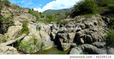 Long exposure view of a hidden river in Crimea, Ukraine. A stone set against a blurred water pattern is ideal for background use. 88289118