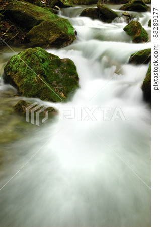 Long exposure view of a hidden river in Crimea, Ukraine. A stone set against a blurred water pattern is ideal for background use. 88289177
