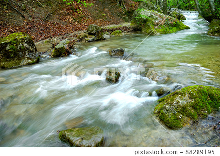 Long exposure view of a hidden river in Crimea, Ukraine. A stone set against a blurred water pattern is ideal for background use. 88289195
