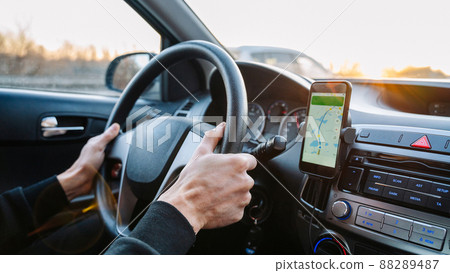 Navigation auto map system. Global positioning system on smartphone screen in auto car on travel road. GPS navigation with smartphone application system. Navigation auto map system. Global positioning system on smartphone screen in auto car on travel road. GPS navigation with smartphone application system. 88289487