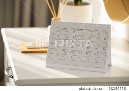Paper calendar on white chest of drawers indoors Paper calendar on white chest of drawers indoors 88289558
