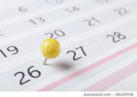 Calendar page marked with drawing pin, closeup 88289596