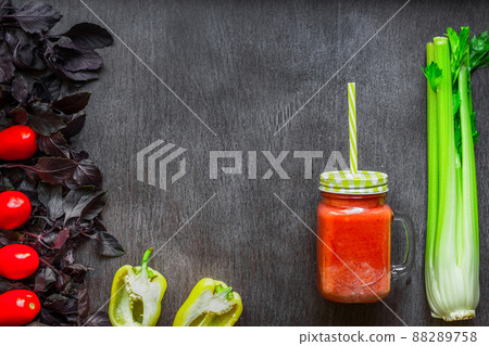 Spicy tomato drink with celery and pepper. Tomato drink in jar surrounded of fresh vegetables on a wooden table Spicy tomato drink with celery and pepper. Tomato drink in jar surrounded of fresh vegetables on a wooden table 88289758