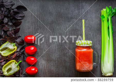 Spicy tomato drink with celery and pepper. Tomato drink in jar surrounded of fresh vegetables on a wooden table Spicy tomato drink with celery and pepper. Tomato drink in jar surrounded of fresh vegetables on a wooden table 88289759