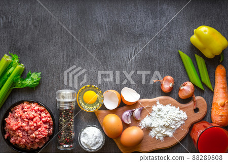 Composition of raw meat with vegetables and spice on wooden background 88289808