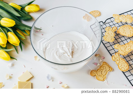 Glass bowl with white cookie icing for decoration. Easter holiday backing 88290081