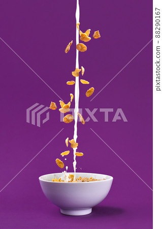 Falling granola with milk splash in bowl. Healthy breakfast ingredients. Flying food 88290167