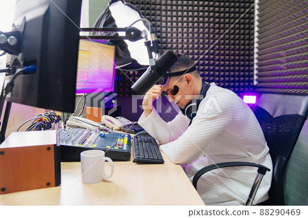 night broadcast. tired radio presenter in sleep mask and cosmetic patches 88290469