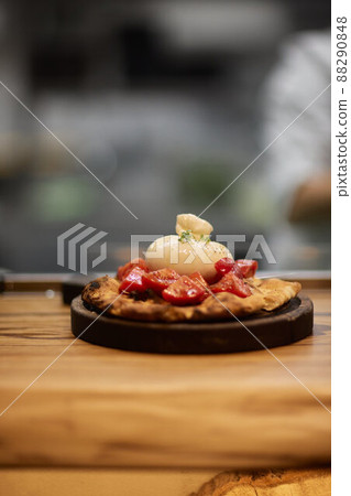 Caprese salad with tomatoes, mozzarella cheese, basil. Dark background. Close up. Top view. 88290848