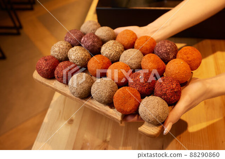 Belper Knolle cheese in the form of small balls. Small Swiss hard cheese balls Belper Knolle. Swiss cheese delicacy concept. Selective focus. 88290860