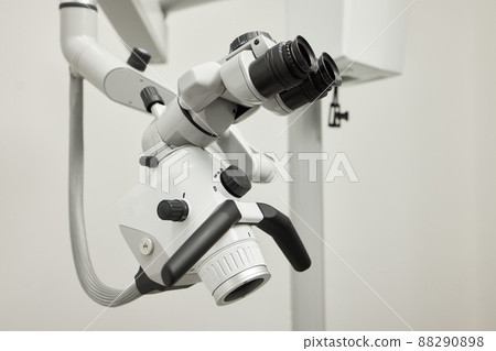 Dental microscope on the background of modern dentistry. Medical equipment. Dental operating microscope with rotary double binocular. 88290898