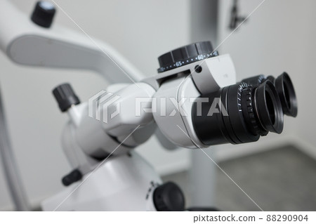 Dental microscope on the background of modern dentistry. Medical equipment. Dental operating microscope with rotary double binocular. 88290904