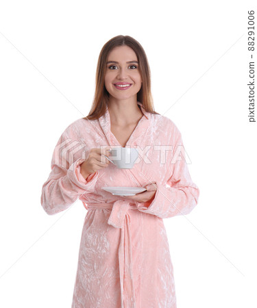 Young woman in bathrobe with cup of drink on white background 88291006
