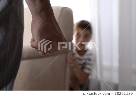 Man threatens his son at home, focus on fist. Domestic violence concept 88291189