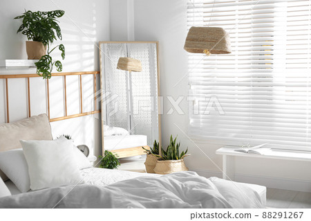 Modern bedroom interior with stylish large mirror Modern bedroom interior with stylish large mirror 88291267