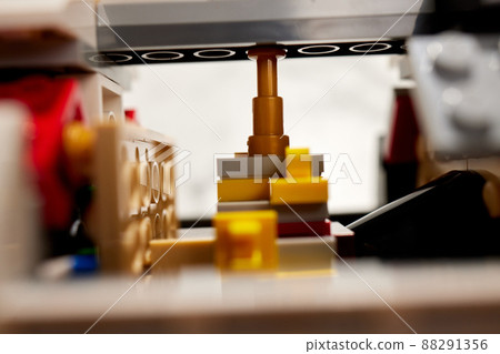 assembling a rocket constructor. colored plastic small blocks. assembling a rocket constructor. colored plastic small blocks. 88291356