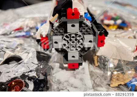 assembling a rocket constructor. colored plastic small blocks. assembling a rocket constructor. colored plastic small blocks. 88291359