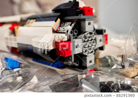 assembling a rocket constructor. colored plastic small blocks. assembling a rocket constructor. colored plastic small blocks. 88291360
