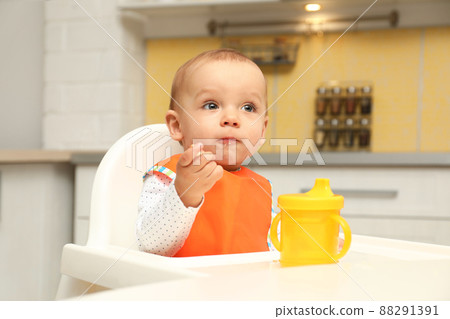Cute little baby eating cookie at home Cute little baby eating cookie at home 88291391