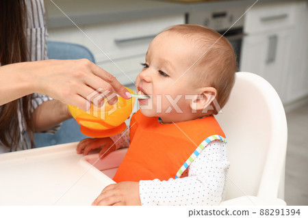 Young mother feeding her little baby at home 88291394